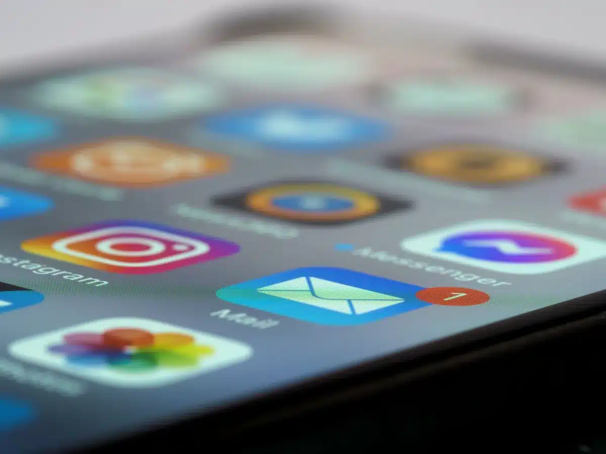 Mano che tiene uno smartphone con notifiche di messaggi e aggiornamenti sullo schermo
