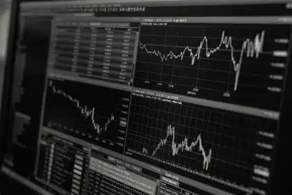 Scrivania con grafici finanziari in calo e documenti aziendali in un ufficio aziendale moderno