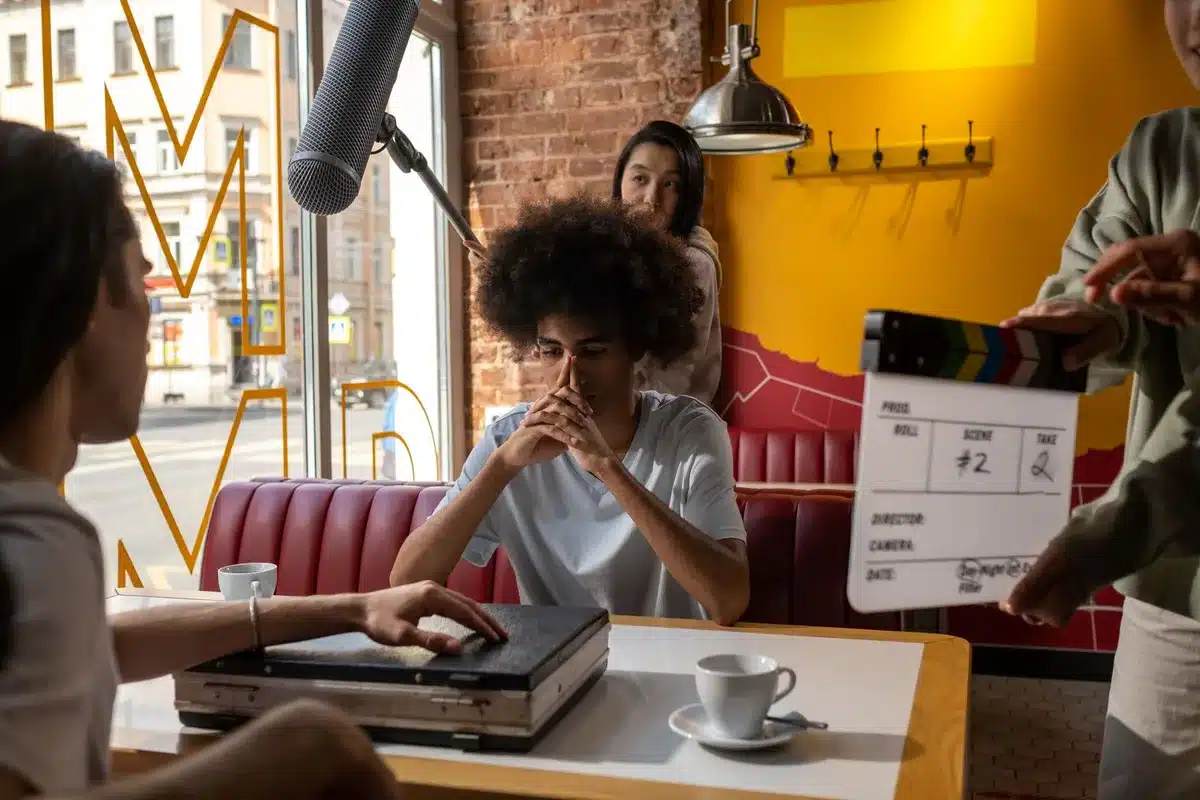 Troupe di produzione e attori durante prove collettive su un set cinematografico