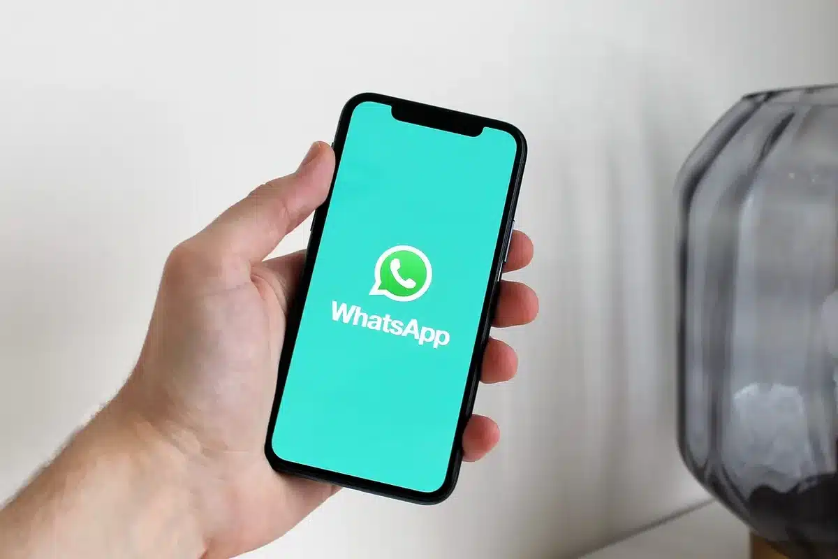 Schermata di uno smartphone con un'icona di avviso di truffa accanto a una bolla di chat